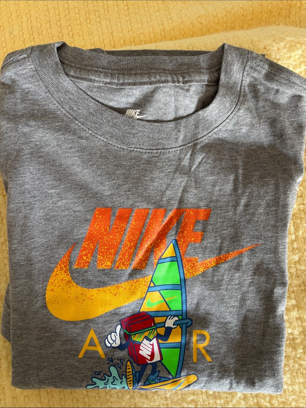 Nike Gray Short-Sleeve Tee with Yellow & Orange Logo and Colorful Surf Graphic